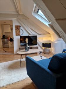 a living room with a couch and a table at Cozy studio Libourne Train station within walking distance in Libourne