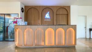 a wooden counter in a room with a sign at Rua Rasada Express in Trang
