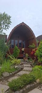 a small circular house with a person standing in the doorway at Bungalow Bangket in Selaparang +5 photos