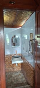 a bathroom with a sink and a mirror at Bungalow Bangket in Selaparang