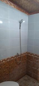 a shower in the corner of a bathroom at Bungalow Bangket in Selaparang