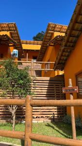 a building with stairs and a fence in front of it at Vila Florença Chales in Santa Teresa