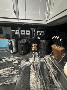 a kitchen with pots and pans on a counter at Cozy 2 Bed Flat in Town Centre in Royal Tunbridge Wells