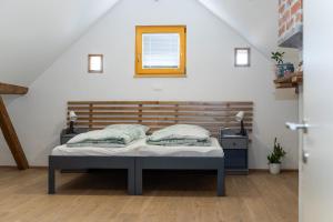 a bedroom with a bed in a attic at Timeless Barn in Ljubljana