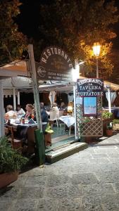 a restaurant with people sitting at tables at night at Kirillos IN CILENTO in Agropoli