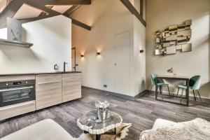 a kitchen and living room with a table and chairs at Loft Studio's in Zandvoort