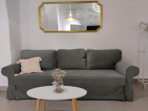 a living room with a couch and a table at La corrala de la calle Sol in Jerez de la Frontera +2 photos