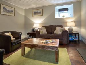 a living room with a couch and a coffee table at Dunvegan Castle Rose Valley Cottage in Dunvegan