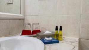 a bathroom counter with two wine glasses and a box at Rua Rasada Express in Trang +31 photos