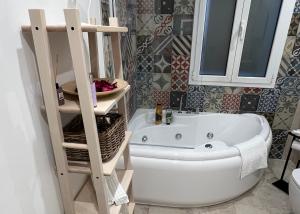 a bathroom with a white bath tub and a mirror at Independent Apartments in Modugno in Modugno +5 photos