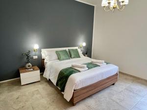 a bedroom with a large bed with green pillows at Independent Apartments in Modugno in Modugno