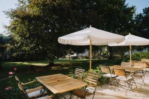 a group of tables and chairs with umbrellas at KAROLINGERHOF - Mosel in Kröv