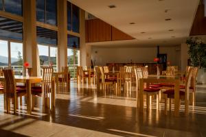 a dining room with wooden tables and chairs at Hostería Huinganco in Huinganco