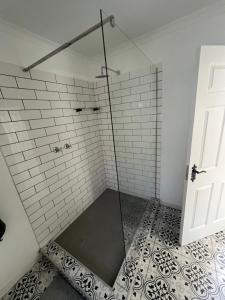 a shower with a glass door in a bathroom at Maple and Vine in Hilton +23 photos