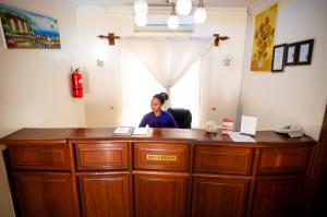 a woman sitting at a desk in an office at Explora Lodge in Arusha