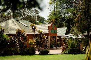 a brick house with a green roof with plants at Explora Lodge in Arusha