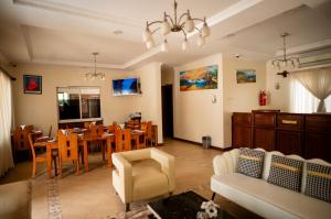 a living room with a table and a dining room at Explora Lodge in Arusha