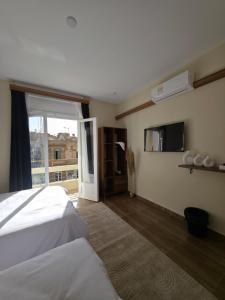 a bedroom with a bed and a window with a view at Swisstay Downtown Cairo in Cairo