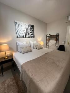 a bedroom with two beds with a zebra picture on the wall at Carmen Rooms -- Boutique B&B by the sea in Nerja +32 photos