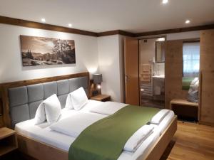 a bedroom with a large bed with a green blanket at Denggnhof in Münster +51 photos