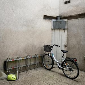a bike parked next to a wall with a basket at Instant Angers Hyper Centre in Angers