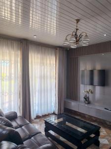 a living room with a couch and a coffee table at Bulawayo Bliss - Cozy 3 Bedroom House in Bulawayo