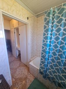 a bathroom with a shower and a bath tub at Bulawayo Bliss - Cozy 3 Bedroom House in Bulawayo +19 photos