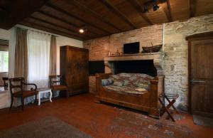 a living room with a stone fireplace and a couch at La Longère du Sallay in Saincaize-Meauce