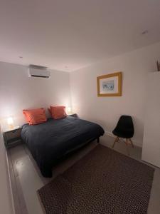 a bedroom with a bed with two orange pillows at Le magasin in Conca