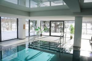 a house with a swimming pool with glass walls at Schönhier - Design Apartment mit Pool, Sauna in Schluchsee