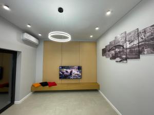 a room with a couch and paintings on the wall at House by River in Yerevan