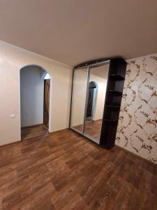 an empty room with a mirror on the wall at Терновской район in Kryvyi Rih