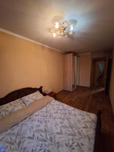 a bedroom with a bed and a ceiling fan at Терновской район in Kryvyi Rih +1 photo