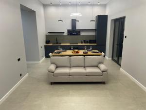 a living room with a couch and a kitchen at House by River in Yerevan