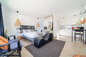 a bedroom with a bed and a table and a kitchen at Riad Salt Pool Bliss Apartamentos in Torremolinos +13 photos