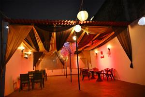 a room with tables and chairs and a tent at Hotel Rainbow in Yamunānagar