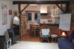 a living room with a table and chairs at Le chant des sirènes in Mettet