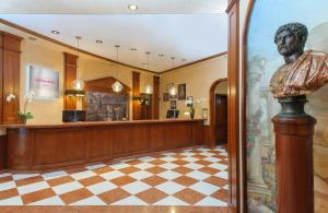a large lobby with a waiting room with a statue at Leonardo Hotel Milan City Center in Milan +44 photos