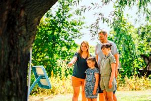 a family posing for a picture in a park at Riverside Essential Clover Caravan Pet 1 in Wooler