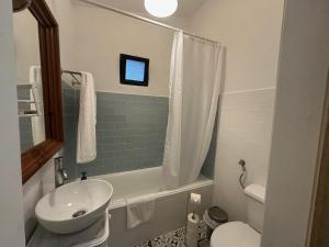 a small bathroom with a sink and a toilet at Refúgio Alentejano in Estremoz +18 photos
