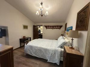 a bedroom with a bed and a chandelier at Refúgio Alentejano in Estremoz