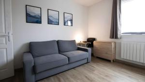 a living room with a couch and a table at T2 Calme proche de la citadelle in Arras