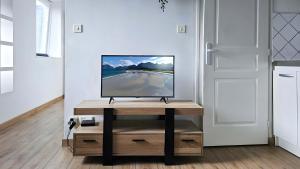 a television sitting on a table in a room at T2 Calme proche de la citadelle in Arras