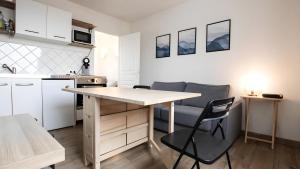 a kitchen with a table and chairs in a room at T2 Calme proche de la citadelle in Arras +10 photos