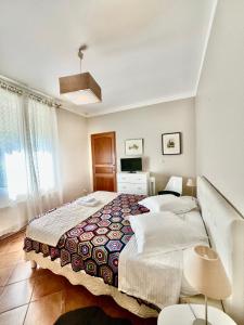 a bedroom with a large bed and a television at La Maison De Maria in Folembray