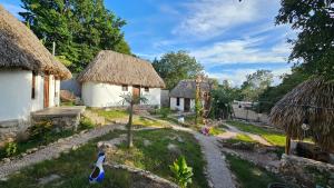 a model of a garden with two huts at Cabañas Los Gallitos Ecolodge 3 in Sacalum