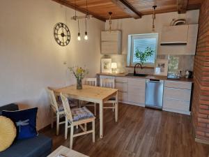 a kitchen and dining room with a wooden table at Mazurski Apartament in Snopki