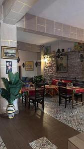 a living room with tables and chairs and a couch at Riad Bladi Essaouira in Essaouira