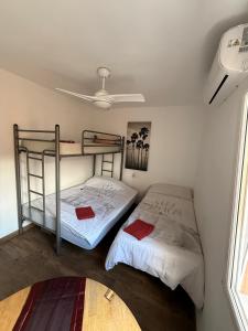 two bunk beds in a room with a ceiling at Casa Alicante Central Apartment with AC 4th floor no elevator in Alicante