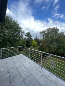 a metal railing on a patio with trees in the background at Stylish spacious residence in Düsseldorf in Düsseldorf
